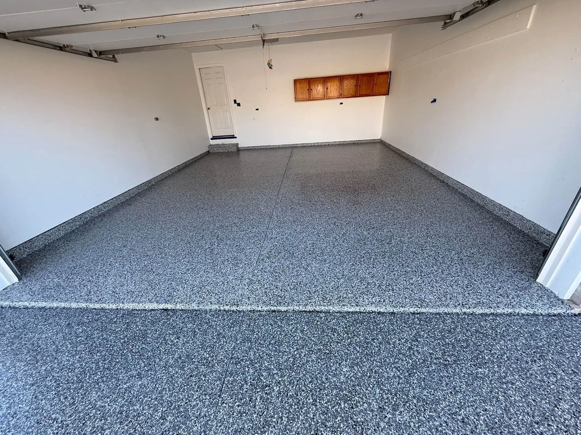 Finished gray flake garage floor by God Given Floors