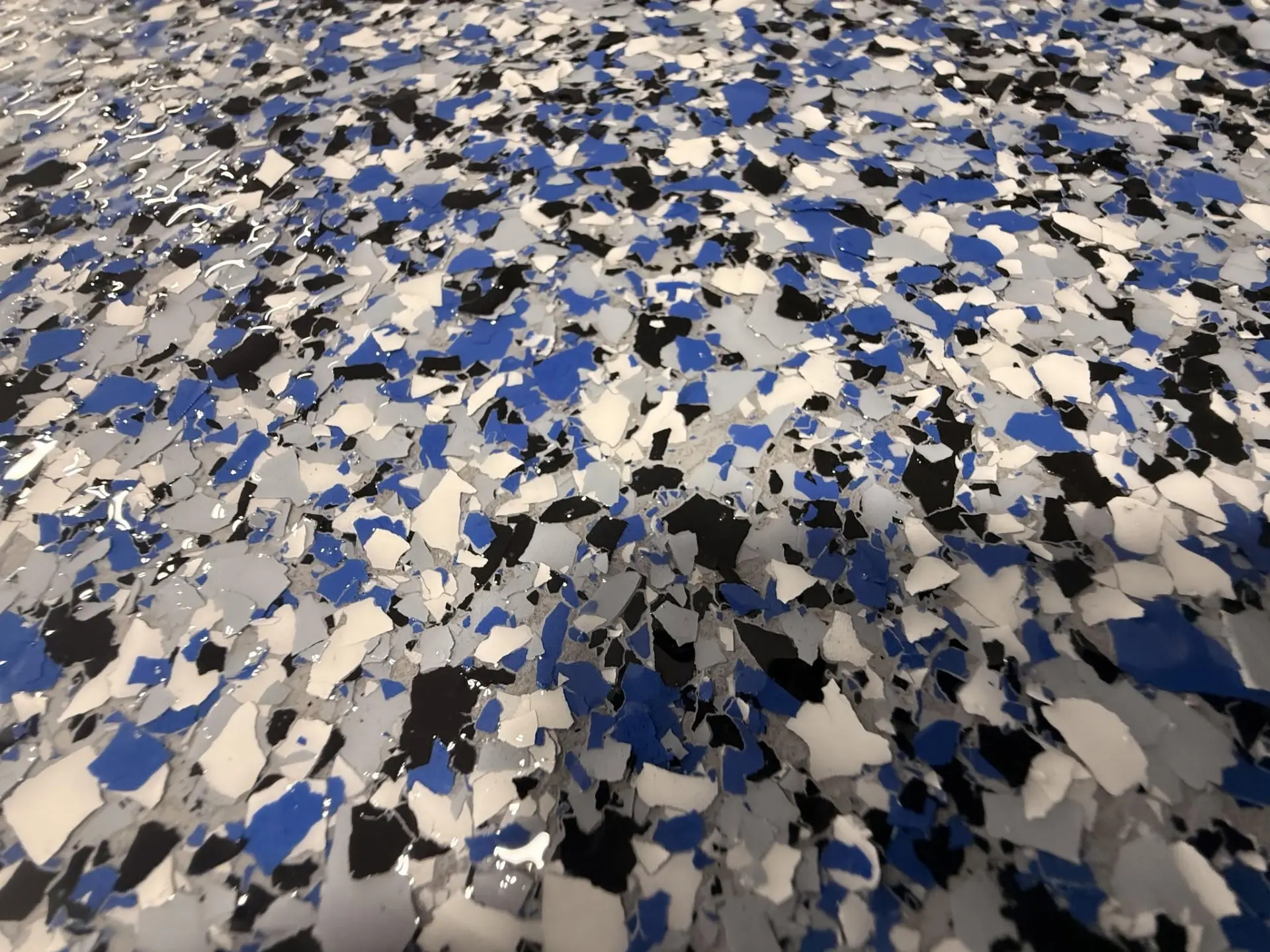 Blue, white, gray and black floor flake detail